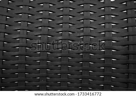 black textured weaving pattern on a furniture closeup curved view