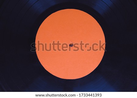 Black music vinyl on a red background top view horizontal photography