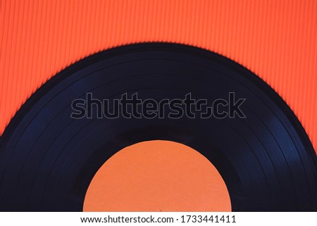 Black music vinyl on a red background top view horizontal photography