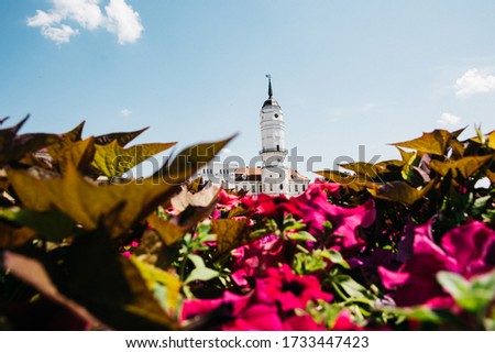 through the colorful flowers shot the church interesting square summer peak roof dome

