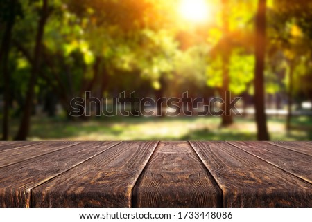 Wooden desk on blur or abstract natural background