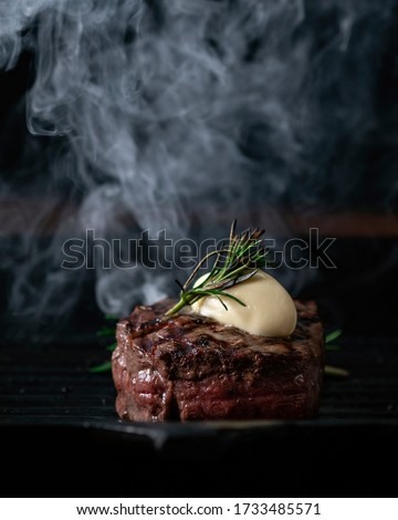 A steaming beef tenderloin steak is grilled in a grill pan with copy space. The concept of the recipe, filet Mignon Royalty-Free Stock Photo #1733485571