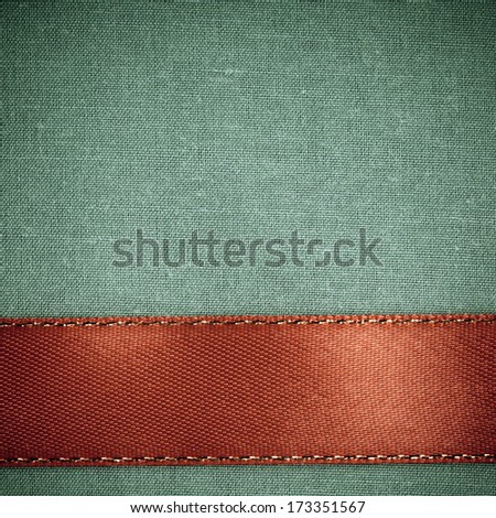 Empty banner on vintage background. Red ribbon on green fabric cloth texture with copy space. Square format