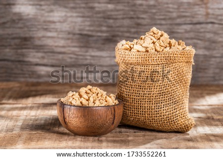 Soy protein textured on old wooden background, close-up