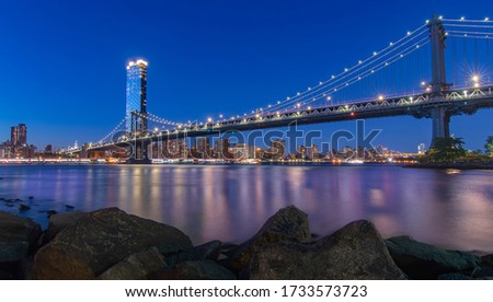 The Manhattan Bridge At night   : It is a suspension bridge that crosses the East River in New York City, connecting Lower Manhattan at Canal Street with Downtown Brooklyn.