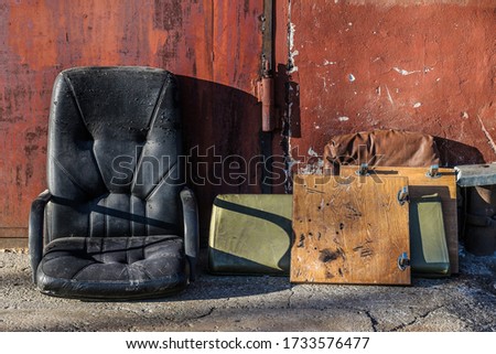Old shabby armchair in the dump