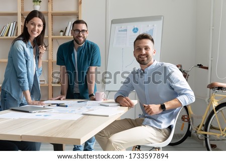 Portrait of smiling team with documents in coworking boardroom looking at camera. Happy diverse corporate staff in negotiation, bank workers photo shoot, HR agency recruitments. Royalty-Free Stock Photo #1733597894