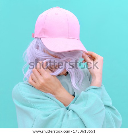 Aesthetic girl in stylish accessories b-boy cap. Fresh pastel colours monochrome fashion design trends Royalty-Free Stock Photo #1733613551