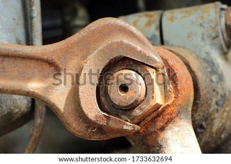 a rusty screw is loosened with a wrench Royalty-Free Stock Photo #1733632694