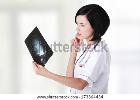 Female doctor or nurse looking at radiography photo