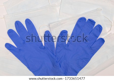 Blue Clean Medical Gloves On Medical Masks On White Background Close-Up.