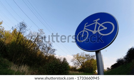 This photo shows a bicycle road sign. It's blue.