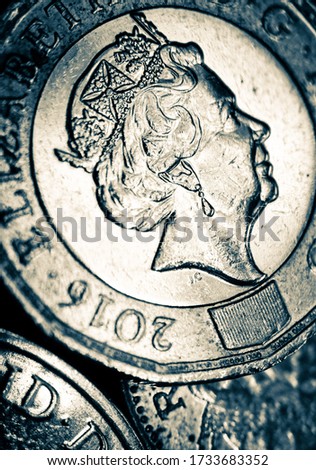 Macro close-up photo of a English coin with embossed queen.