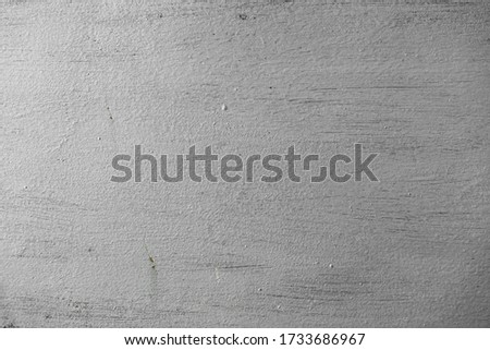 Rough surface of the wall painted in silver color. Abstract textured background. Empty space.