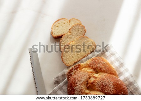 Homemade  fresh wicker bread on a light background.