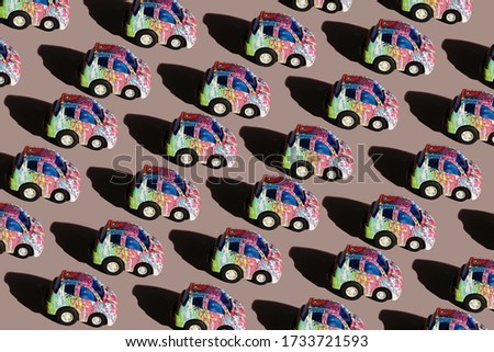Seamless pattern of colored cars on a pink background