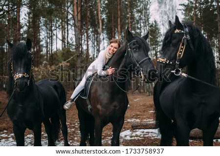 Attractive young woman on a horseback, outdoor portrait.