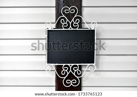 Blank Black Board for writing on the wall mock up or template for your design add your own text. Advertisement empty menu board billboard.