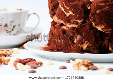 Cream puff cake with chocolate and nuts