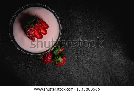 close-up macro photo of strawberry pudding on dark background. Top view. Copy space for text message.