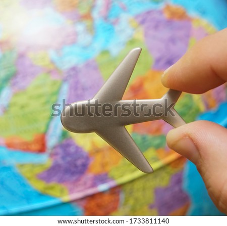 metal, iron toy plane on the globe. Flight travel concept. Travel by airplane. Takeoff and landing of the aircraft. Return home from flight. empty Copy space for inscription.