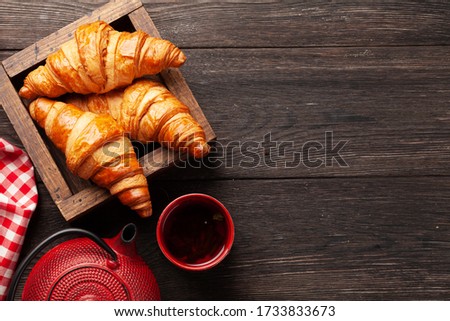 Fresh tasty croissants and tea. Breakfast meal. Top view flat lay with copy space