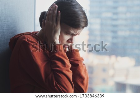 mental health, stress, migraine or depression concept, young sad depressed frustrated autistic woman sitting at home alone suffering from head ache and psychological problems Royalty-Free Stock Photo #1733846339