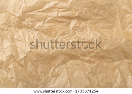 Sheet of Brown Thin Crumpled Craft Paper Parchment Background Top View. Wrinkled Tan Wrapping Paper Texture or Pattern