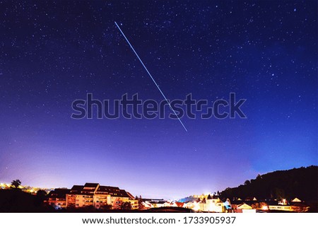Satellites over city in the  night sky.