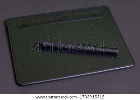 Graphic tablet on a black background.