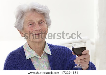 Senior woman holding glass of wine 