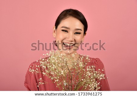 Asian woman glad to receiving a beautiful flower bouquet, Portrait of happy smiling middle age woman in casual clothes looking at the camera.