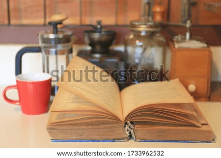 A close up shot of an old book opened on a coffee table selective focus and shallow depth of field