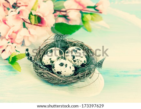 Easter decoration with flowers and eggs in birds nest. Retro style toned picture. Selective focus