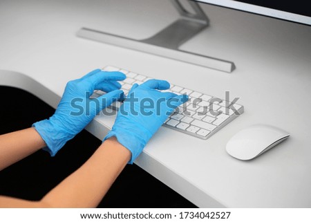 Female receptionist working at desk in clinic