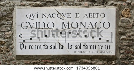 Guido Monaco was born and lived here (Qui nacque ed abitò Guido Monaco). Commemorative street sign for monk Guido Monaco, inventor of the musical notation. Arezzo, Italy. 