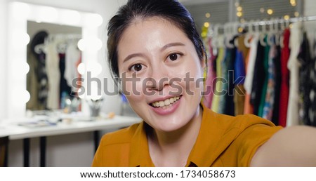 happy young female model taking selfie in backstage dressing room. beautiful female actress cheerful laughing face camera making self portrait. joyful lady performer in makeup place take photo