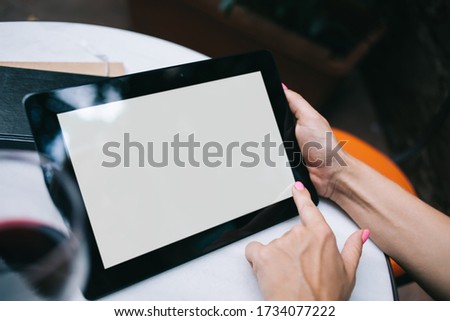 Cropped view of female with modern digital tablet with copy space area for internet advertising, selective focus on hands holding mockup touch pad with blank screen for your web publication