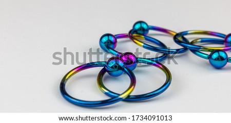Anodized titanium CBR body piercing rings Royalty-Free Stock Photo #1734091013