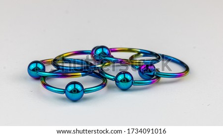 Anodized titanium CBR body piercing rings Royalty-Free Stock Photo #1734091016