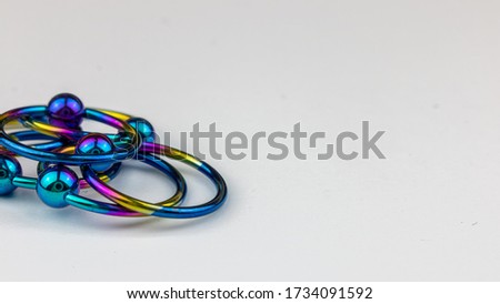 Anodized titanium CBR body piercing rings Royalty-Free Stock Photo #1734091592