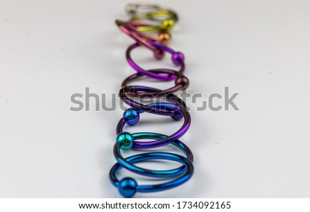 Anodized titanium CBR body piercing rings Royalty-Free Stock Photo #1734092165