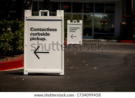 Sign advertising Contactless Curbside Pickup at retail store parking lot Royalty-Free Stock Photo #1734099458
