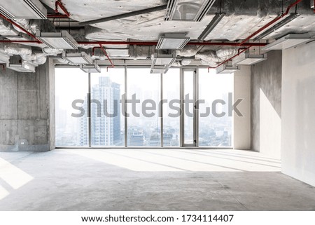 High rise office under construction with open ceiling to see structure and system work, glass windows for take aerial view of buildings in the city. Empty space for developer investment.