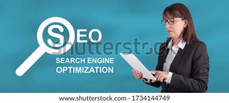Woman using digital tablet with search engine optimization concept on background