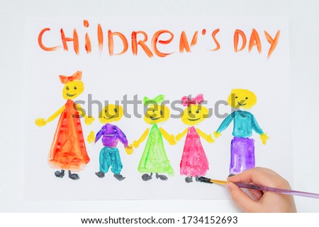 Top view of hand of child drawing the different children with words Children's Day for the holiday Happy Children's Day.