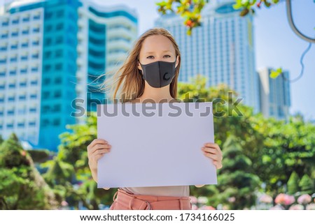 woman in medical mask prevents coronavirus disease holds a poster for free inscriptions. COPY SPACE