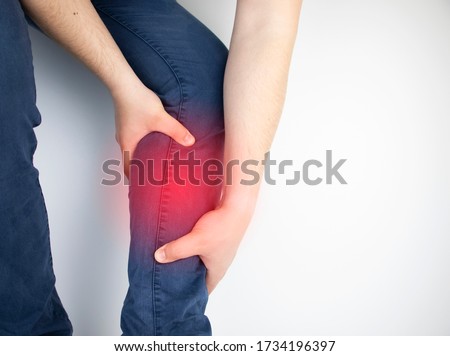 A man suffers from pain in the calves. Stretching the calf muscle, varicose veins, leg cramps, or myositis. Orthopedic doctor examines Royalty-Free Stock Photo #1734196397