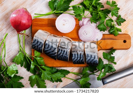 Picture of  tasty  sliced  lightly salted mackerel  with greens and onion 