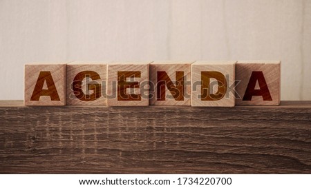 Agenda word on wooden blocks with letters, a list of matters business concept.